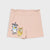 Light pink shorts with a cartoon cow and cat graphic on the left leg, displayed flat against a light gray background.