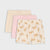 Three pairs of children's shorts stacked together on a light gray background. The top pair is cream with thin orange stripes and a small bow; the middle is light pink with a small bow; the bottom pair is cream with an allover orange cat print.