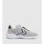 A light gray and white Hummel athletic sneaker with navy blue chevron accents and a white sole, shown from a side profile on a light gray background.