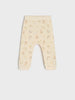 Beige baby leggings with rainbow pattern on a white background