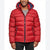 A man wearing a red hooded puffer jacket with a navy blue interior lining and a small Tommy Hilfiger flag logo on the chest, paired with a gray shirt and black pants.