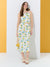 Woman wearing a floral dress with lemon pattern against a yellow and white background