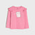 A pink long-sleeve children's top with ruffled shoulder details and a white cartoon dog graphic on the front, displayed against a light gray background.