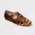 Leopard print flat shoe with a round toe and thin strap on a light gray background