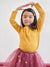 Young girl wearing a yellow top and pink skirt with a white background