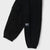 Black cargo pants with elastic cuffs, featuring a side cargo pocket with a white 'BNYC' brand label, shown on a light gray background.