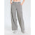 A person wearing light gray wide-leg cargo pants with side flap pockets, shown from the waist down against a plain light gray studio background.