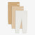 Three pairs of ribbed knit baby leggings in beige, tan, and white, arranged in a staggered stack on a light gray background.