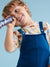 Child wearing a blue dress overalls holding a toy against a light blue background with a cashback offer overlay.