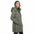 A woman wearing a mid-length olive green hooded puffer coat with black zipper details, shown in profile against a plain white background.