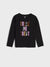 Black long-sleeve shirt with 'Trick or Treat' text in colorful letters on a light gray background