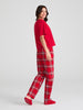 Woman wearing red plaid pajamas on a white background
