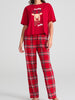 Red pajama set with reindeer design and 'holly jolly' text on a gray background