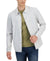 Man wearing a light gray jacket over a green shirt with a white background