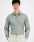 Man wearing a green checkered shirt against a white background