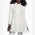 A model wearing a cream-colored double-breasted coat with gold buttons, shown from the neck down against a plain white background.
