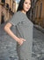 Woman wearing a black and white striped dress on a street.