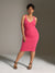 Woman wearing a pink dress against a neutral background