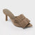 Beige high-heeled sandal with frayed details on a light gray background