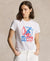 Woman wearing a white t-shirt with a graphic design on a beige background