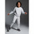 A young boy wearing a light gray sweatshirt and matching jogger pants, posing dynamically against a dark gray studio background.
