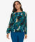 Woman wearing a blue patterned blouse and blue pants on a white background