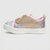 A single children's low-top sneaker with a silver and pink sequined upper, a gold glitter bow detail, black rhinestone toe studs, and a thick white platform sole, shown against a light gray background.