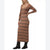 A woman modeling a long-sleeve ribbed knit midi dress in a brown and beige plaid pattern, paired with black ankle boots, against a plain white background.