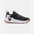 A black and white athletic sneaker with a textured knit upper, a black bull logo on the side, and a white midsole with a gum outsole.