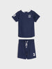 Navy blue children's swim set with white accents on a light gray background
