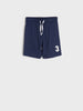 Navy blue shorts with a white number three on a light gray background