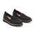 Pair of black slip-on shoes with brown soles on a white background