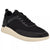 A black low-top sneaker with a textured mesh upper, black laces, a black rubber toe cap, and a thick cream-colored midsole and outsole, shown from a three-quarters angle on a white background.