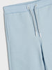 Light blue sweatpants with a drawstring on a light gray background