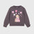A dark gray long-sleeve sweatshirt for toddlers, featuring a cute cartoon girl and dog graphic on the front surrounded by pink and white pom-poms and flowers. The sweatshirt has gathered cuffs and a ribbed crew neck, hem, and sleeves.