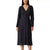 A woman modeling a long-sleeve midi dress with a dark navy base and a dense white micro-dot pattern, paired with black strappy sandals against a plain white background.