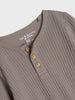 Close-up of a ribbed gray shirt with buttons and 'fox & bunny' branding.