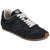 A low-top sneaker in black suede with white laces, a tan gum outsole, and a black tongue label featuring the 'coach' brand logo.