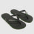 A pair of black Havaianas flip-flops with a textured grip, featuring the white Havaianas logo and a thin green and white stripe along the edge, set against a light gray background.