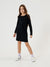 Young girl wearing a black dress on a white background