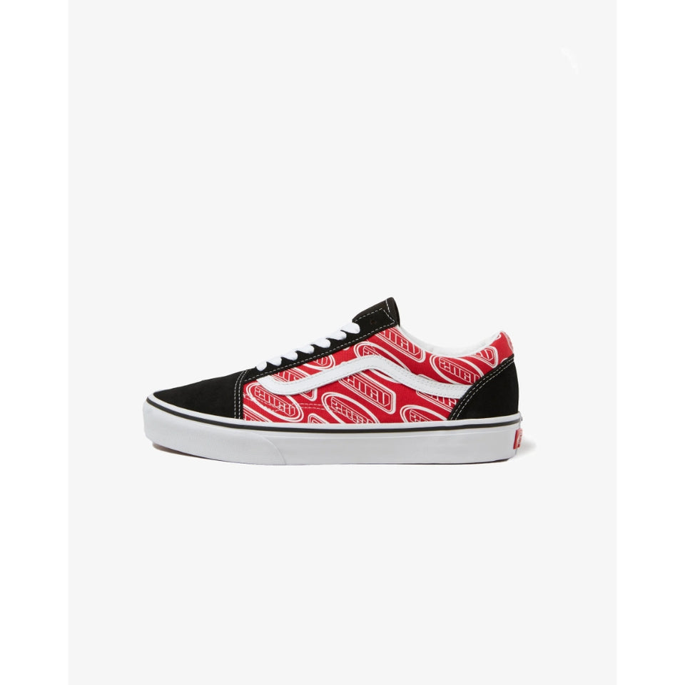 A single Vans Old Skool sneaker shown in a side profile on a clean white background. The shoe features a black canvas toe and heel, a white canvas midfoot with a red and white Vans logo pattern, white laces, and a white rubber sole.