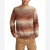 A man wearing a crewneck knit sweater with horizontal stripes in shades of brown, rust orange, and beige, paired with tan pants against a white background.
