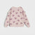 A light pink long-sleeve sweatshirt for toddlers, featuring an all-over pattern of darker pink bows and ruffle details on the shoulders, displayed against a light gray background.
