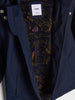 Navy blue jacket with a patterned lining and visible brand label.
