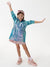 Child wearing a colorful raincoat with arms outstretched on a white background