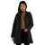 A woman modeling a black diamond-quilted hooded coat over a brown turtleneck sweater and black pants, set against a plain white background.