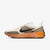 Beige and brown running shoe with Nike logo on a white background