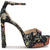A single women's high-heeled platform sandal with an ankle strap, featuring a black base covered in a multicolor floral and botanical pattern with orange, green, and cream details. It has a chunky block heel and a small gold buckle on the strap, shown against a plain white background.