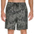 Tropical leaf patterned shorts on a white background