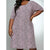 A woman wearing a short-sleeve knee-length dress with an allover leopard print pattern in pink and black, posed against a light gray studio background.